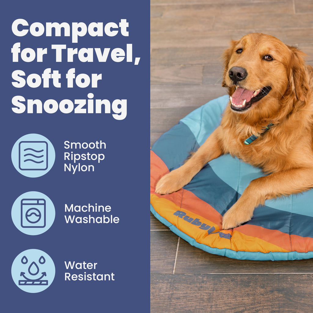 A golden retriever rests on the Travel Dog Bed—foldable, packable for travel, made of smooth ripstop nylon. It’s soft, machine washable, water resistant, and perfect for road trips or camping.